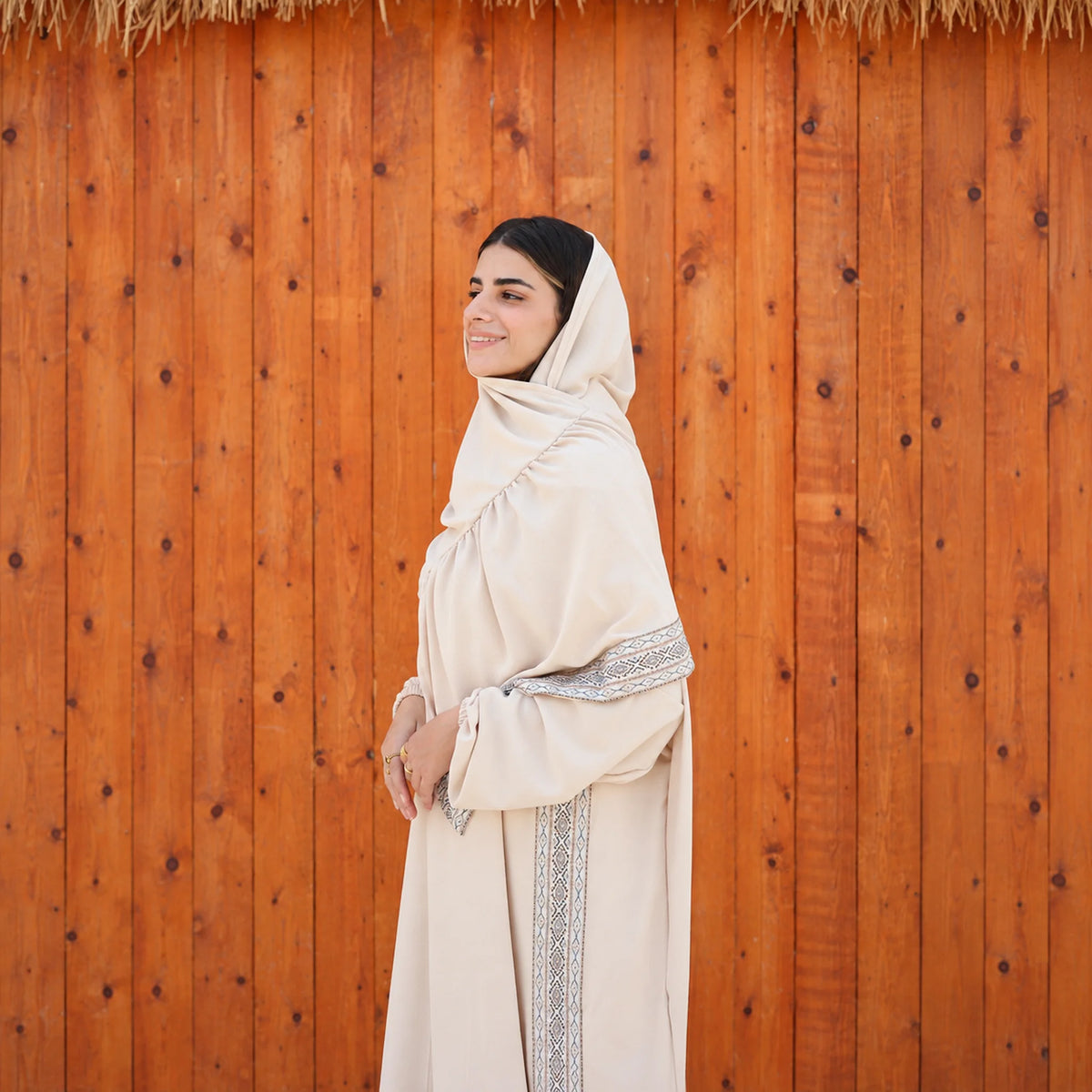 Model wearing Tallah's beige CY Isdal with vertical trim panel, gallery photo 5