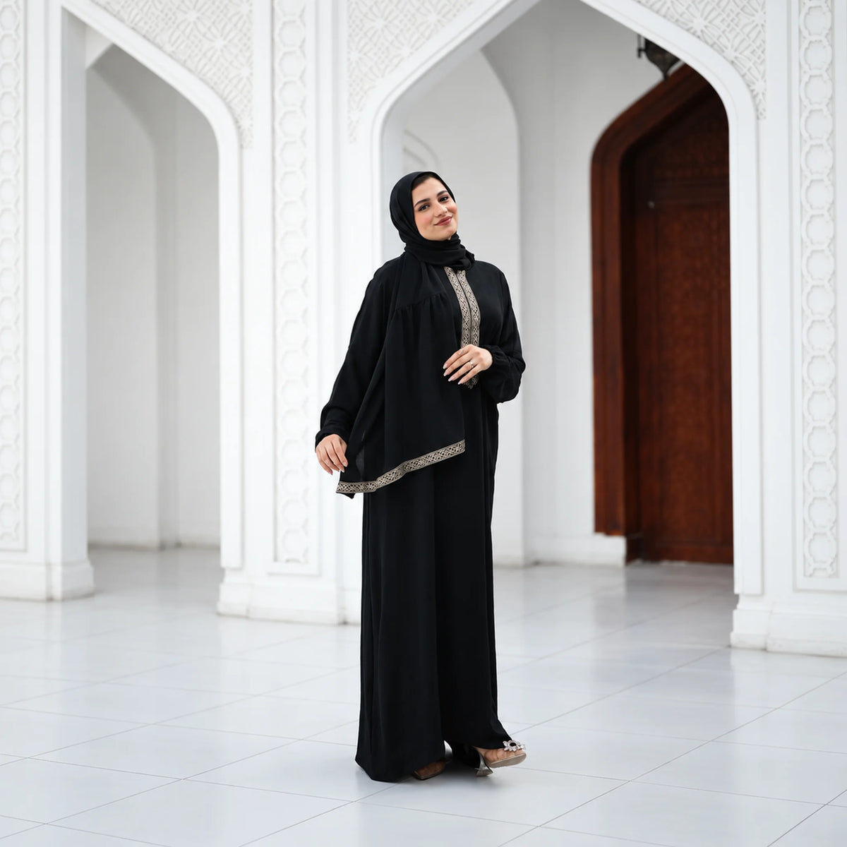 Model wearing Tallah's black CY Isdal with diagonal gold trim, gallery photo 3