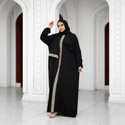 Model wearing Tallah's black CY Isdal with gold panel and belt, gallery photo 1