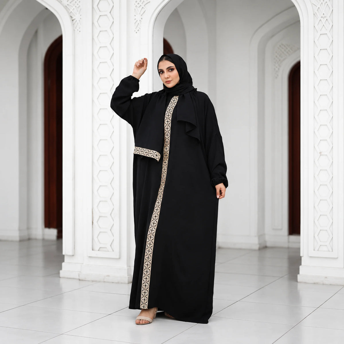 Model wearing Tallah's black CY Isdal with gold panel and belt, gallery photo 1