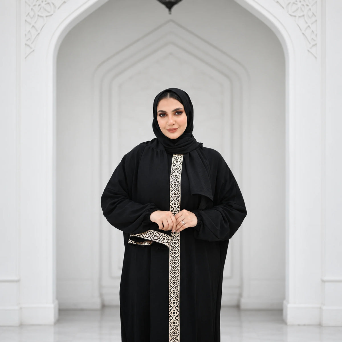 Model wearing Tallah's black CY Isdal with gold panel and belt, gallery photo 2