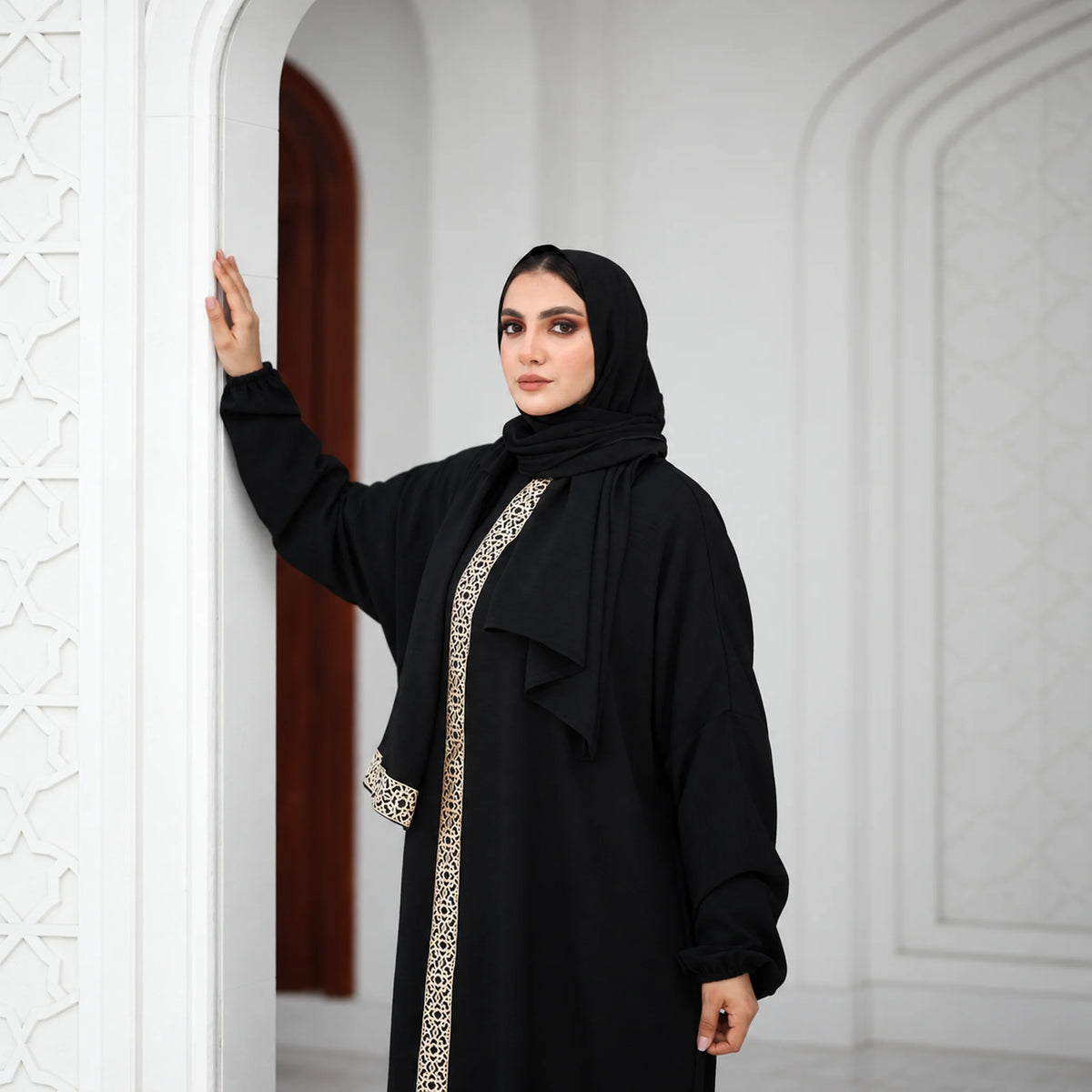 Model wearing Tallah's black CY Isdal with gold panel and belt, gallery photo 3
