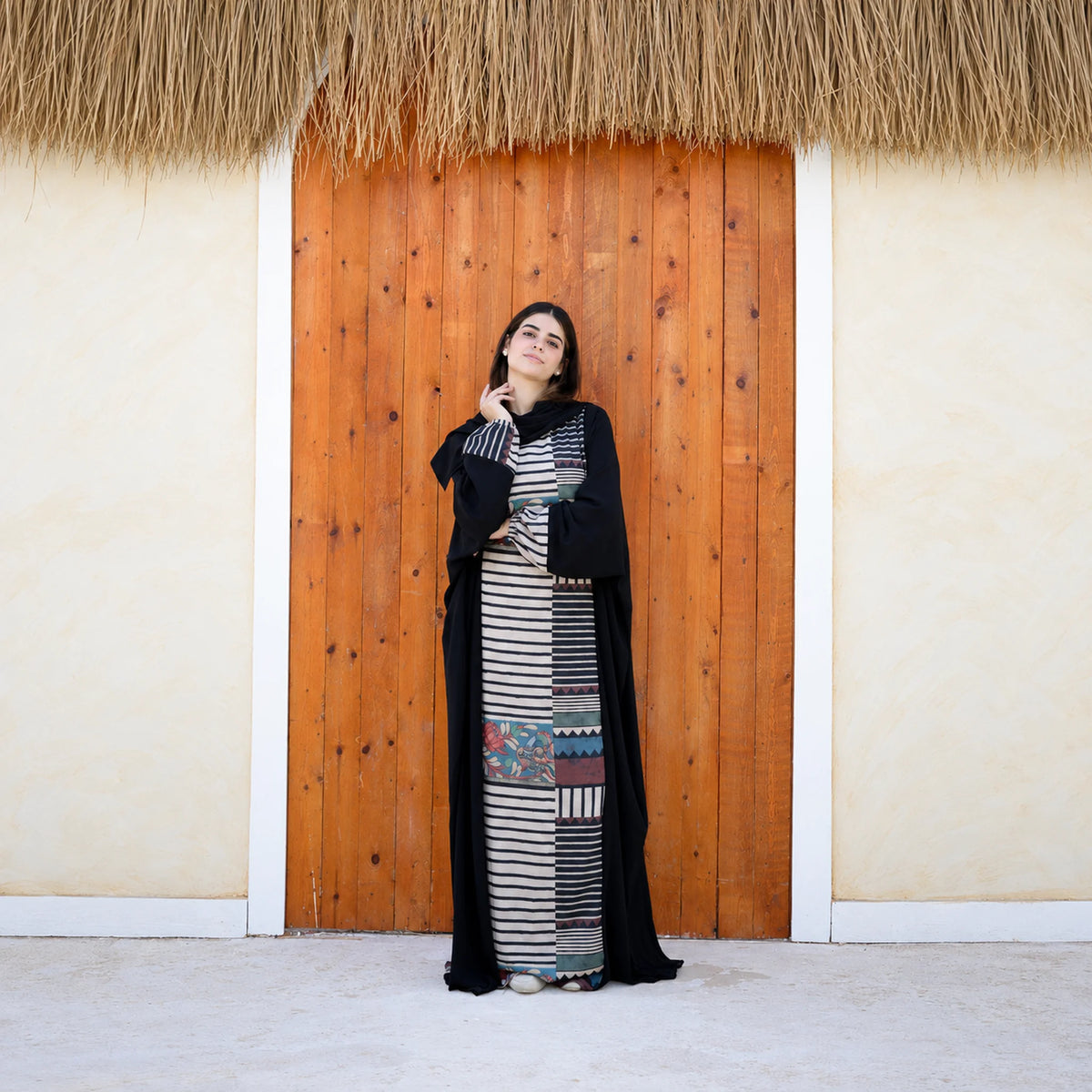 Model wearing Tallah's black CY Isdal with mixed-print split panel, gallery photo 1