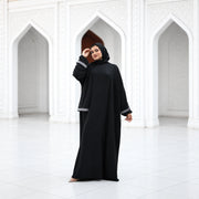 Model wearing Tallah's black CY Isdal with silver cuff trim, gallery photo 1