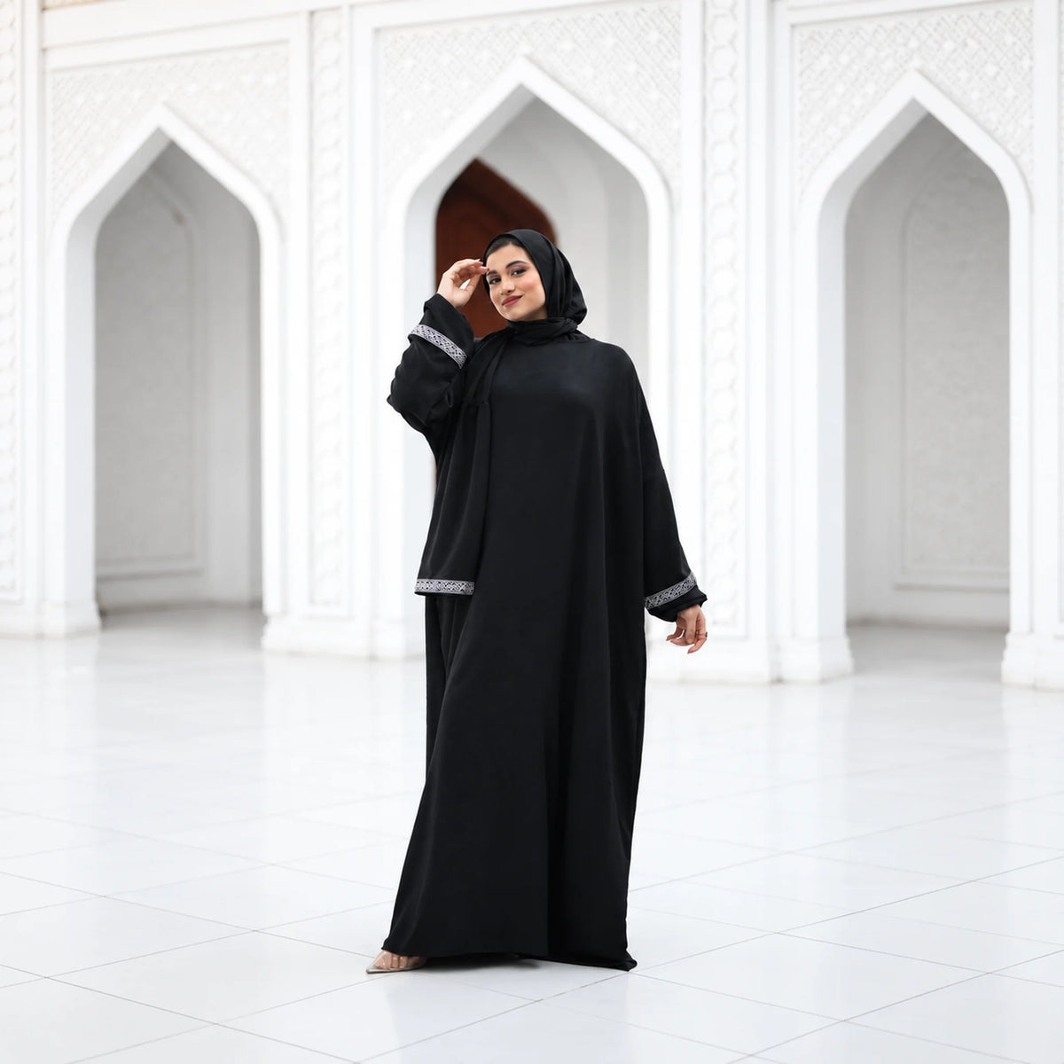 Model wearing Tallah's black CY Isdal with silver cuff trim, gallery photo 1