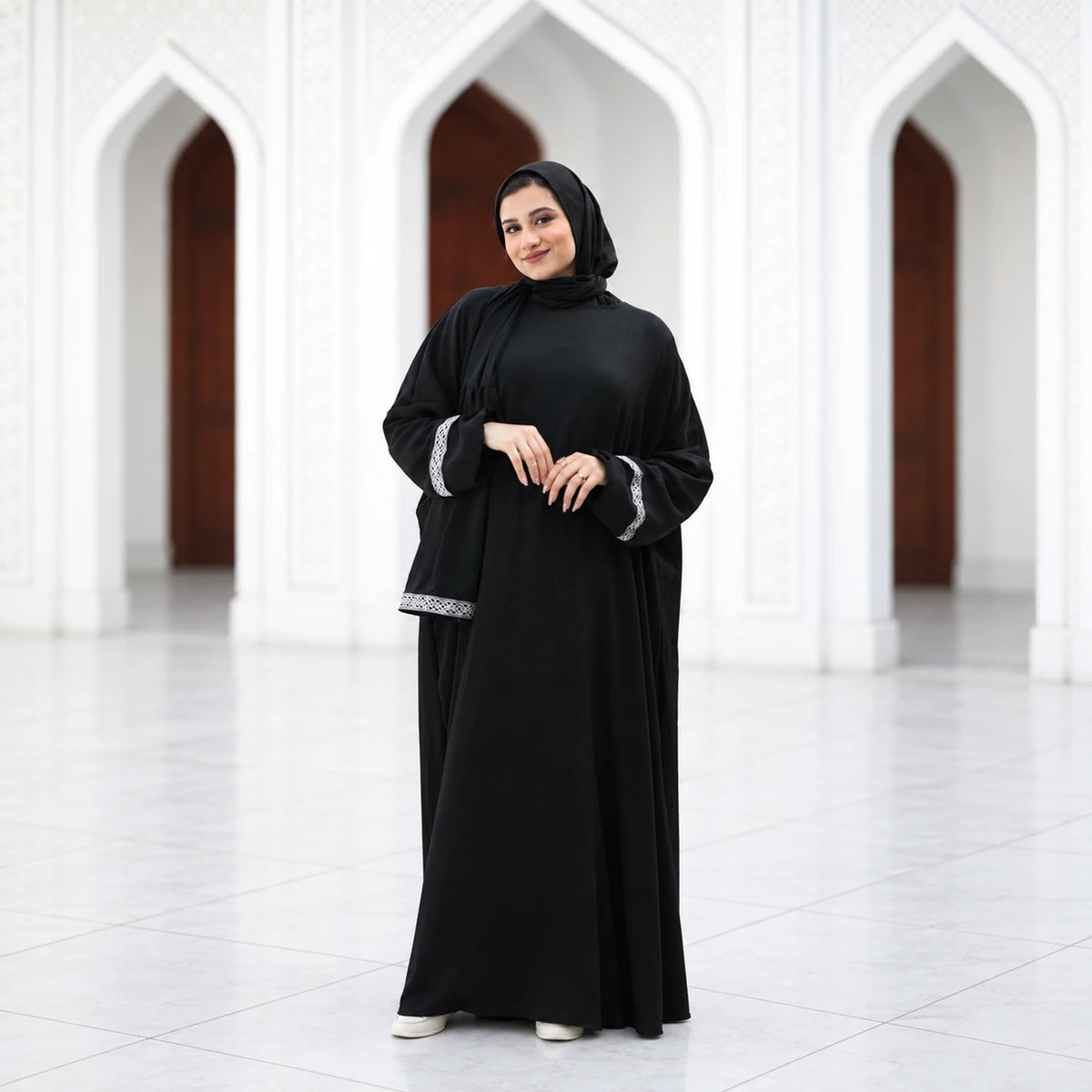 Model wearing Tallah's black CY Isdal with silver cuff trim, gallery photo 2