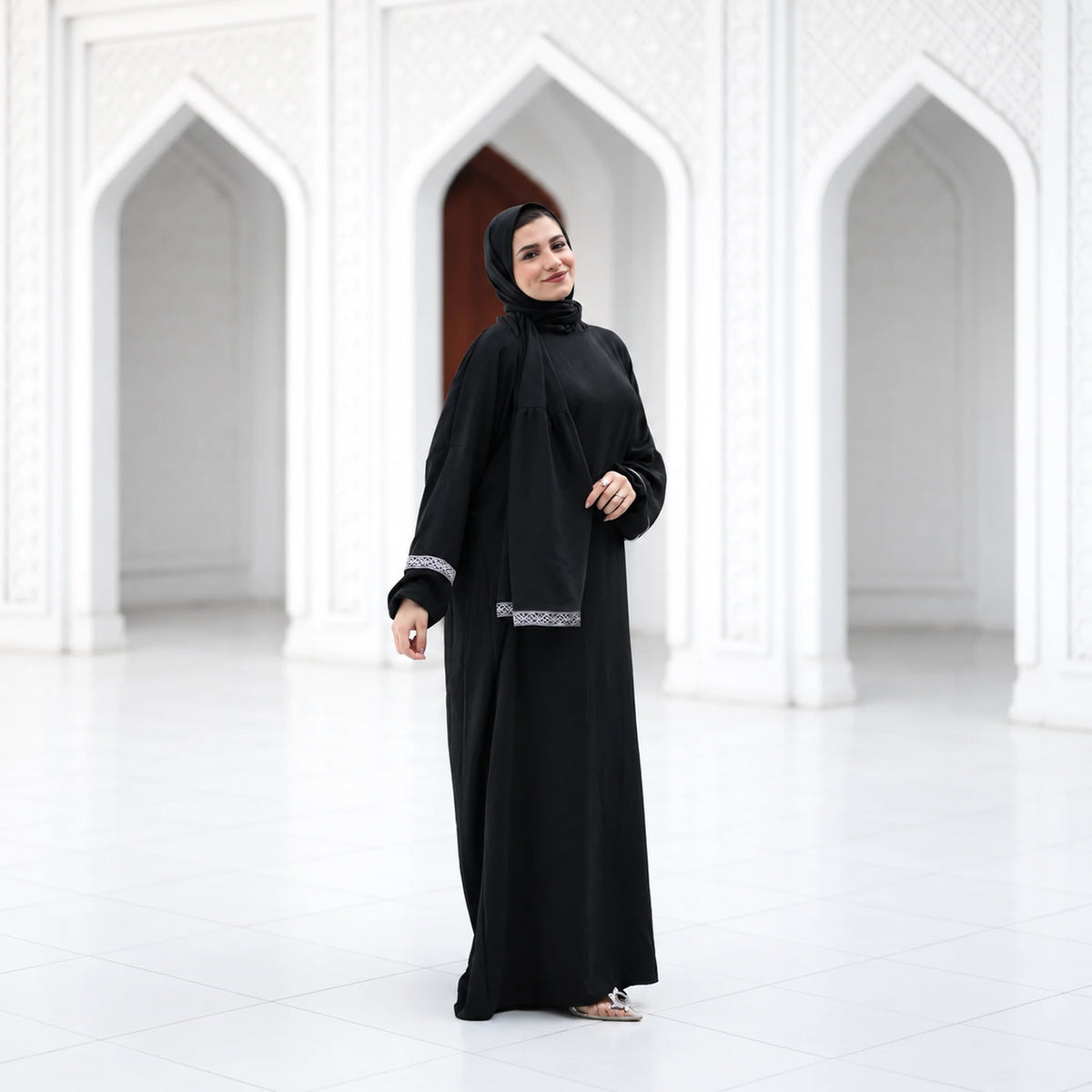 Model wearing Tallah's black CY Isdal with silver cuff trim, gallery photo 3