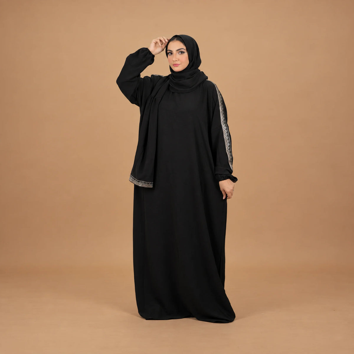 Model wearing Tallah's black CY Isdal with silver trim on sleeves and hem, gallery photo 3