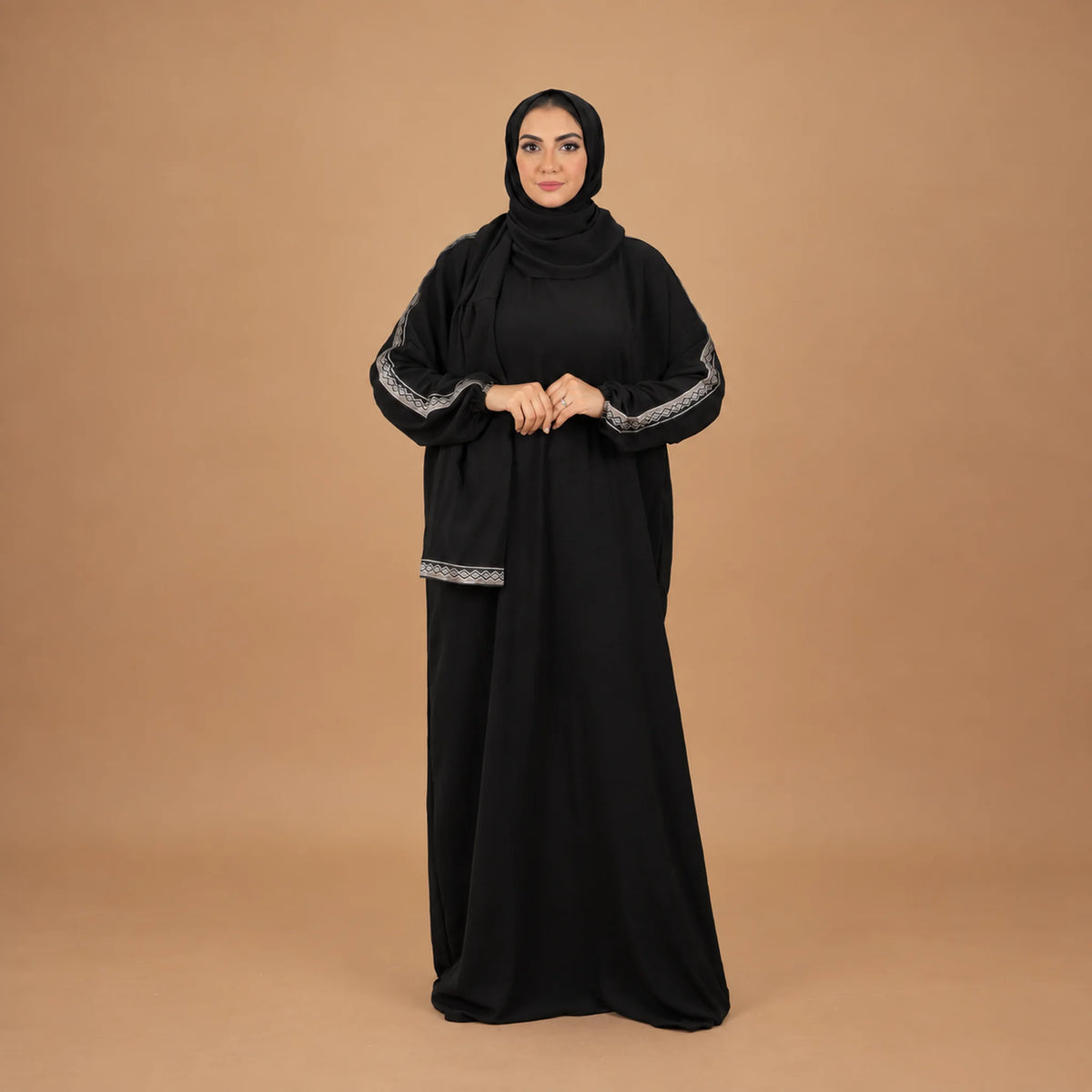 Model wearing Tallah's black CY Isdal with silver trim on sleeves and hem, gallery photo 4