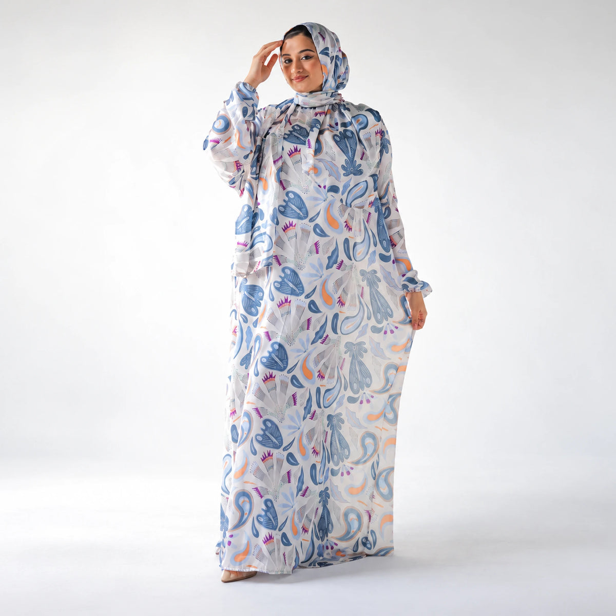 Full-length front view of a blue and white CY Isdal with an abstract print and peach and purple accents.