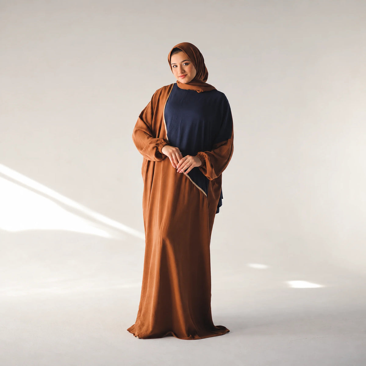 Model wearing Tallah's brown CY Isdal with navy colour-block panel, gallery photo 2