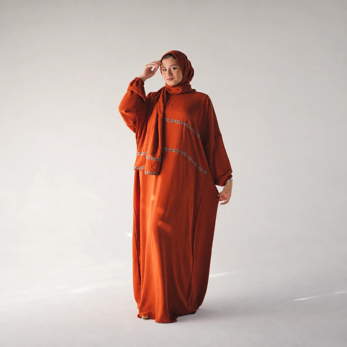 Model wearing Tallah's burnt-orange CY Isdal with leopard trim, gallery photo 2