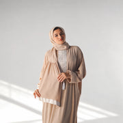 Model wearing Tallah's coffee-brown CY Isdal with white panel trim, gallery photo 1