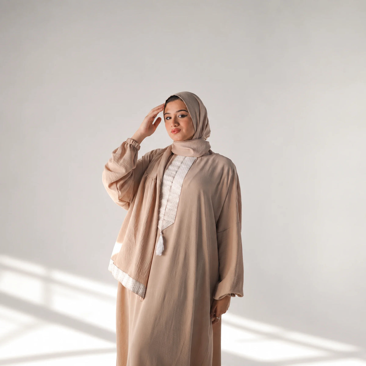 Model wearing Tallah's coffee-brown CY Isdal with white panel trim, gallery photo 2