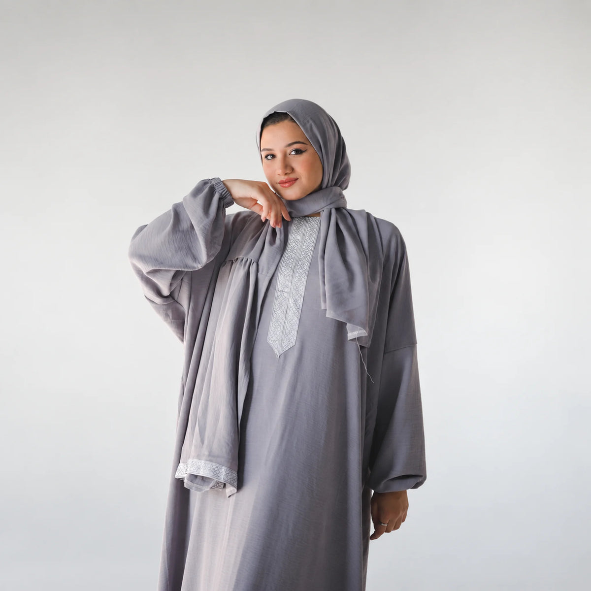 Model wearing Tallah's grey CY Isdal with vertical embroidered panel, gallery photo 1
