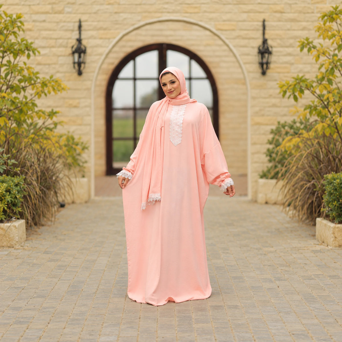 Model wearing Tallah's pink CY Isdal with lace trim, gallery photo 1
