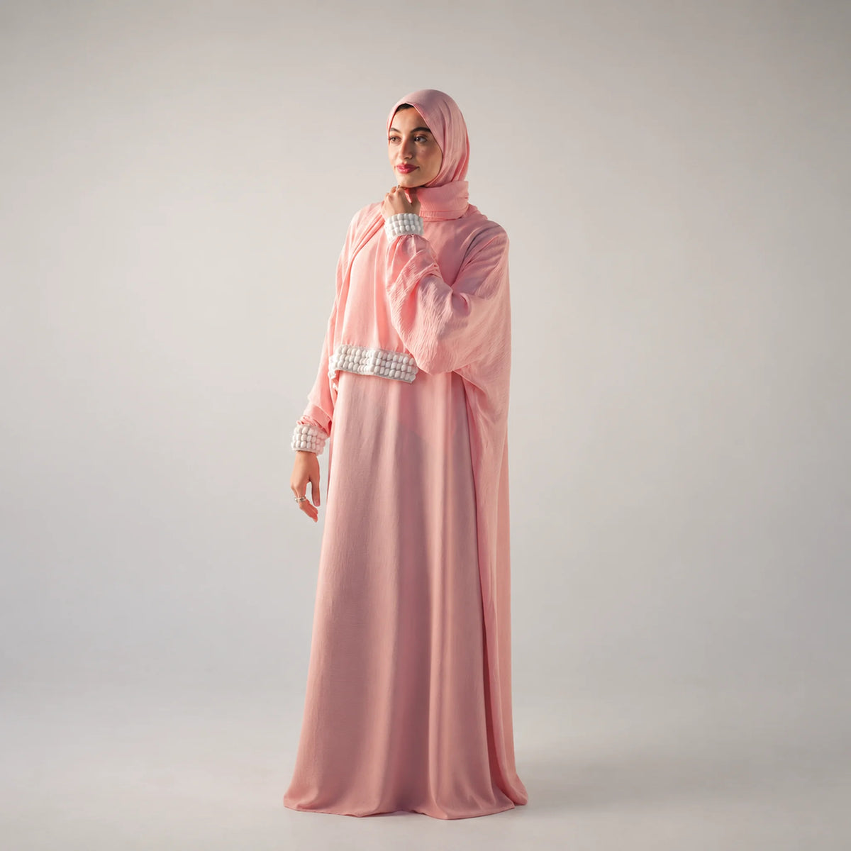 Model wearing Tallah's pink CY Isdal with pearl cuff trim, gallery photo 2