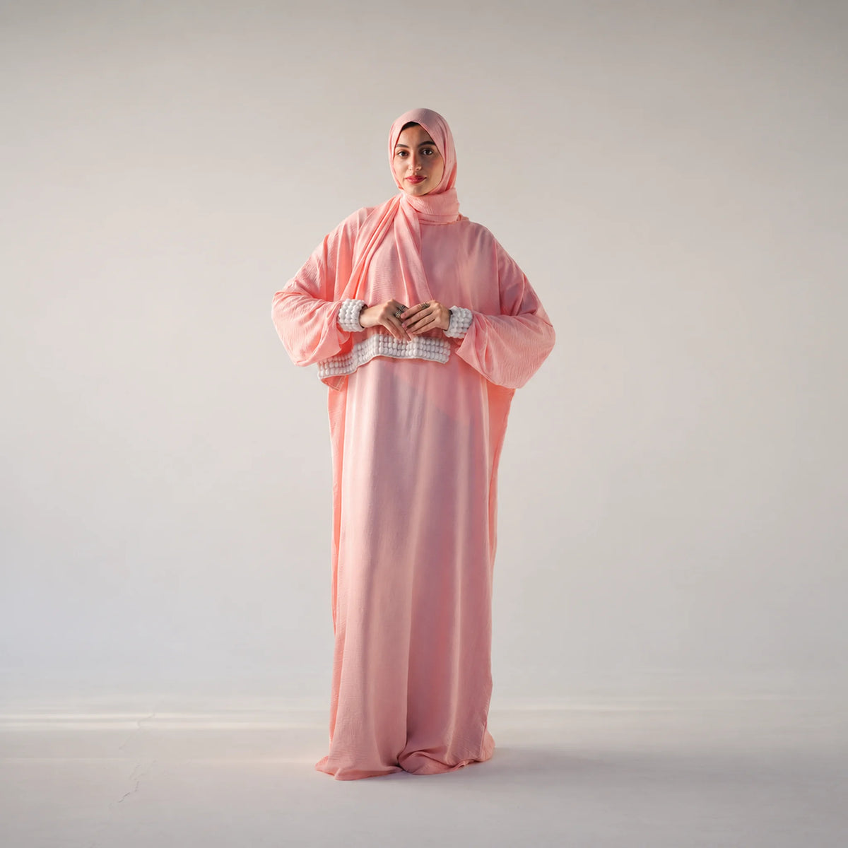 Model wearing Tallah's pink CY Isdal with pearl cuff trim, gallery photo 3