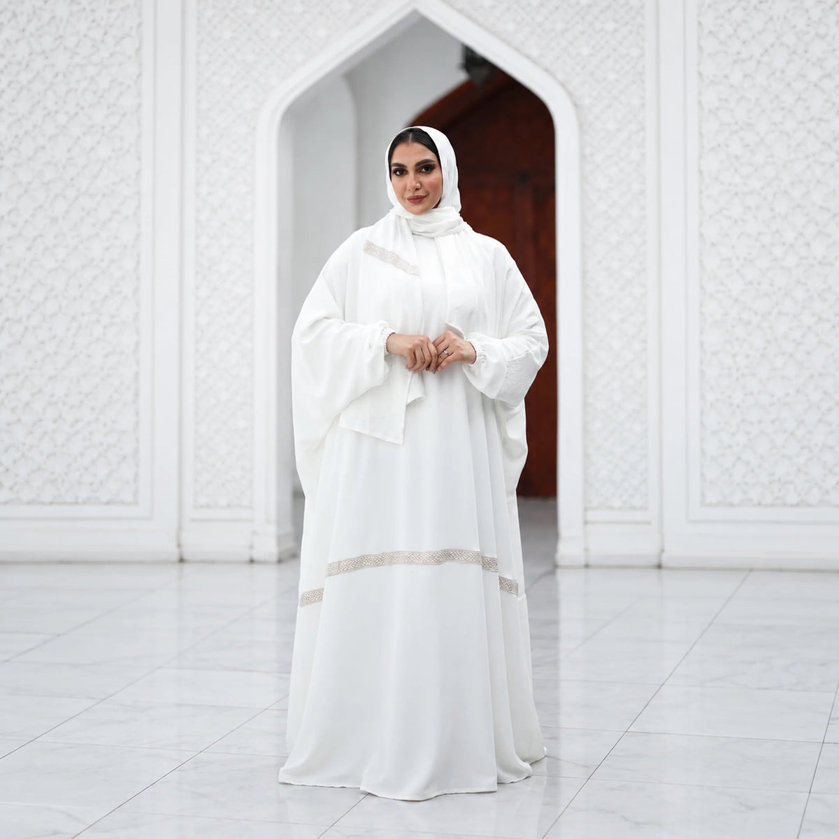 Model wearing Tallah's white CY Isdal with diagonal beaded trim, from the Hajj & Umrah line, gallery photo 3