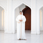 Model wearing Tallah's white CY Isdal with gold beaded trim, gallery photo 1
