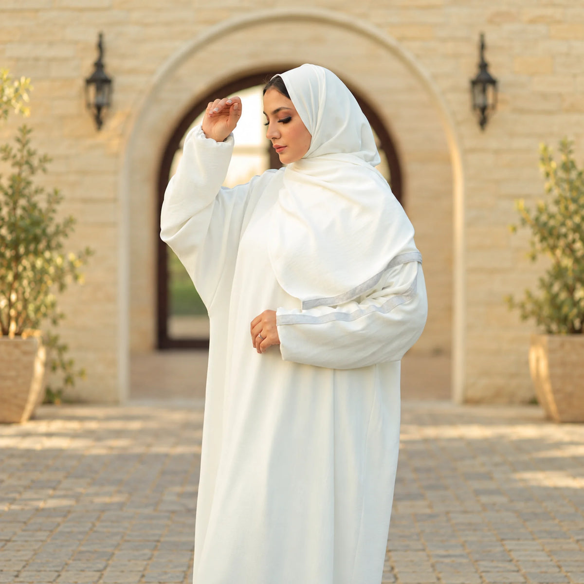 Model wearing Tallah's white CY Isdal with grey stripe cuff trim, gallery photo 1