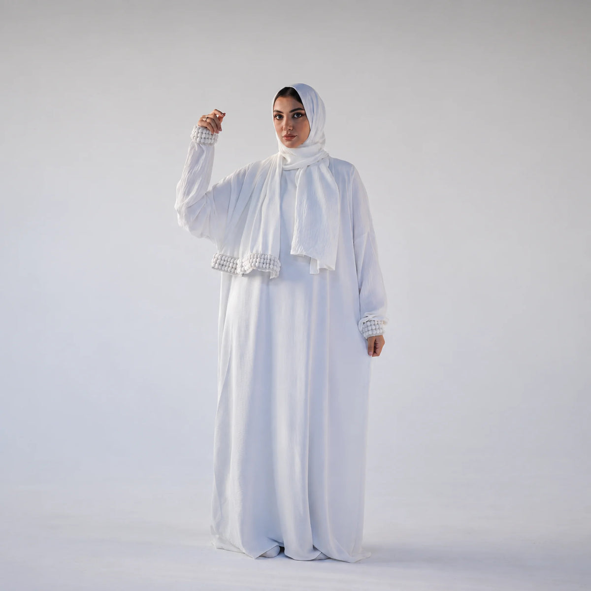 Model wearing Tallah's white CY Isdal with pearl cuff trim, gallery photo 1