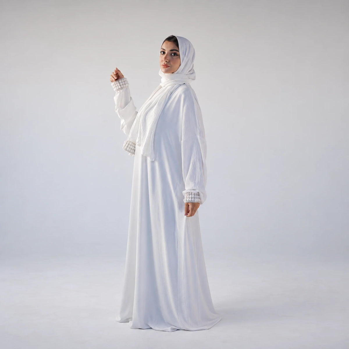 Model wearing Tallah's white CY Isdal with pearl cuff trim, gallery photo 2
