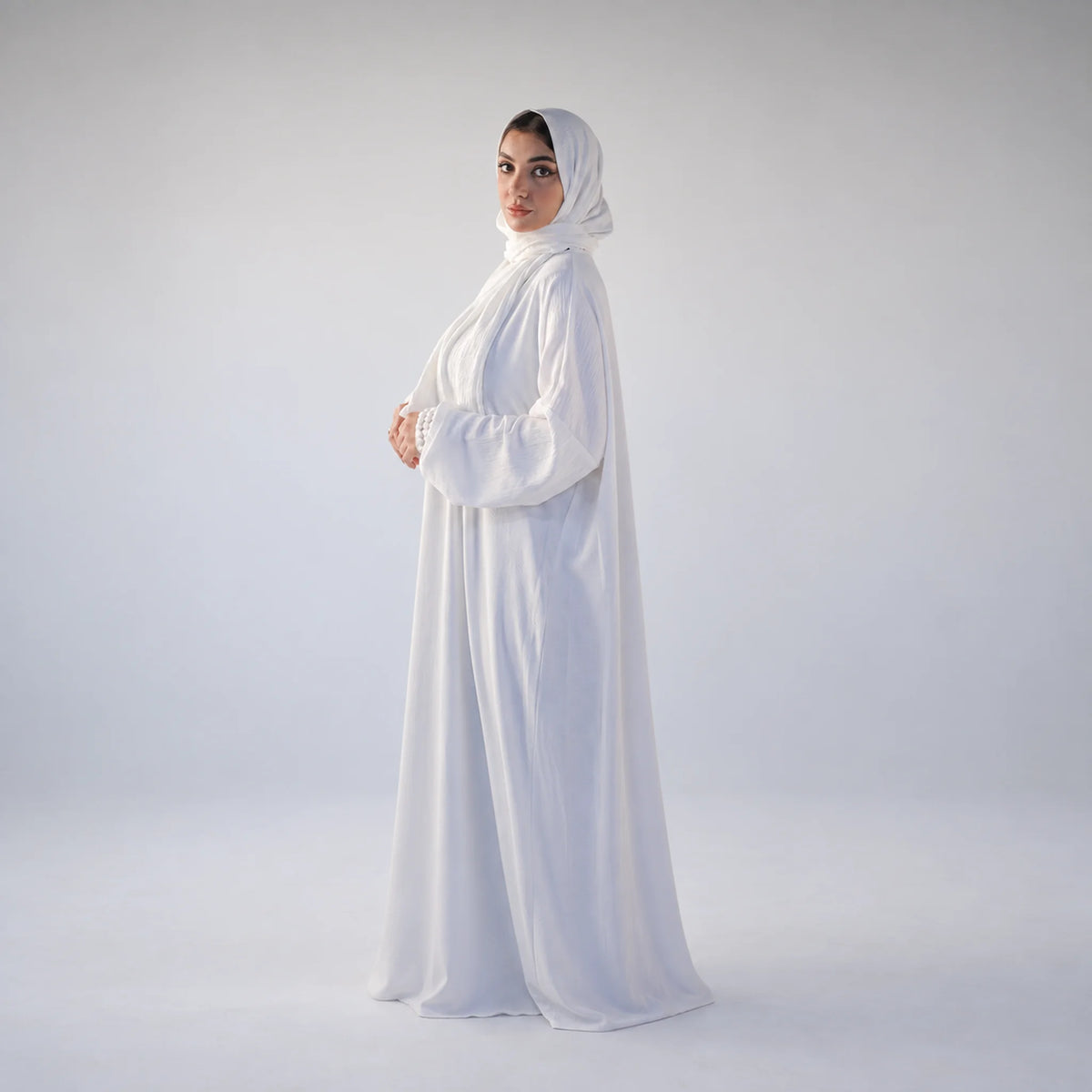 Model wearing Tallah's white CY Isdal with pearl cuff trim, gallery photo 3