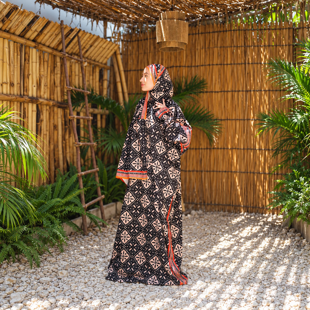 Isdal in Soft Mabrad in Black & cream, geometric print with orange trim with matching veil, gallery view 1.