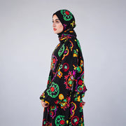 Side view of Tallah's black Soft Mabrad Isdal with multicolour floral medallions and matching veil.