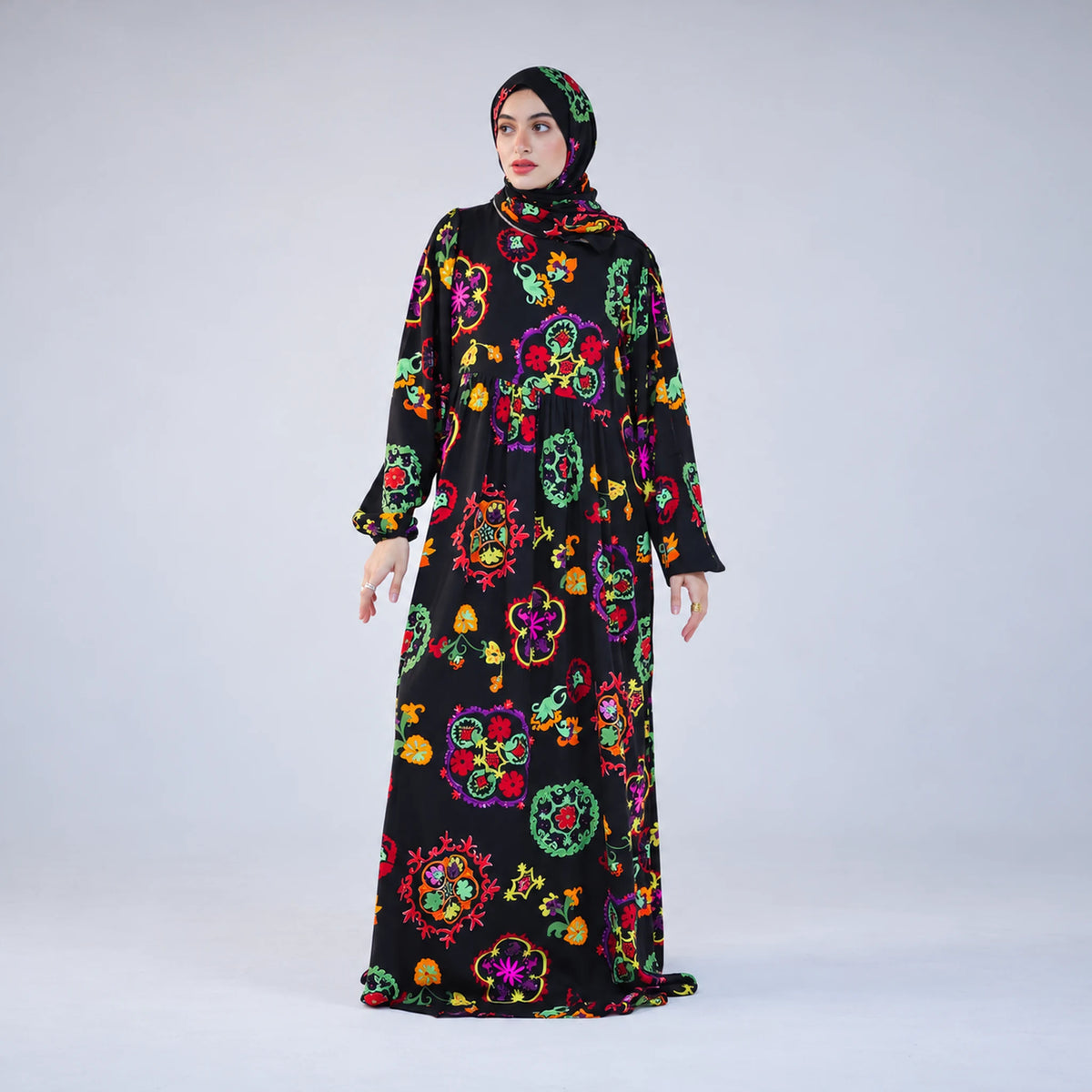 Model wearing Tallah's black Soft Mabrad Isdal with multicolour floral medallions and matching veil, full-length front view.