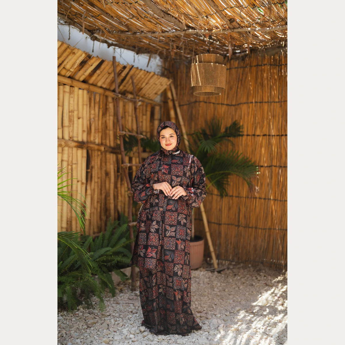 Tallah satin Isdal in Black and Rust, patchwork pattern, full-length front view with hands together.