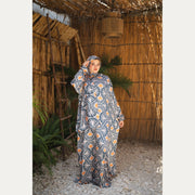 Tallah satin Isdal in Navy, Cream and Orange, fan pattern, full-length front view with hand near head.