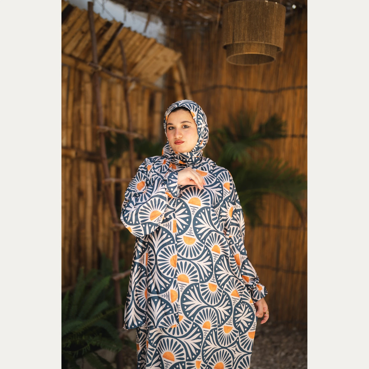 Tallah satin Isdal in Navy, Cream and Orange, fan pattern, upper-body view showing matching head covering.
