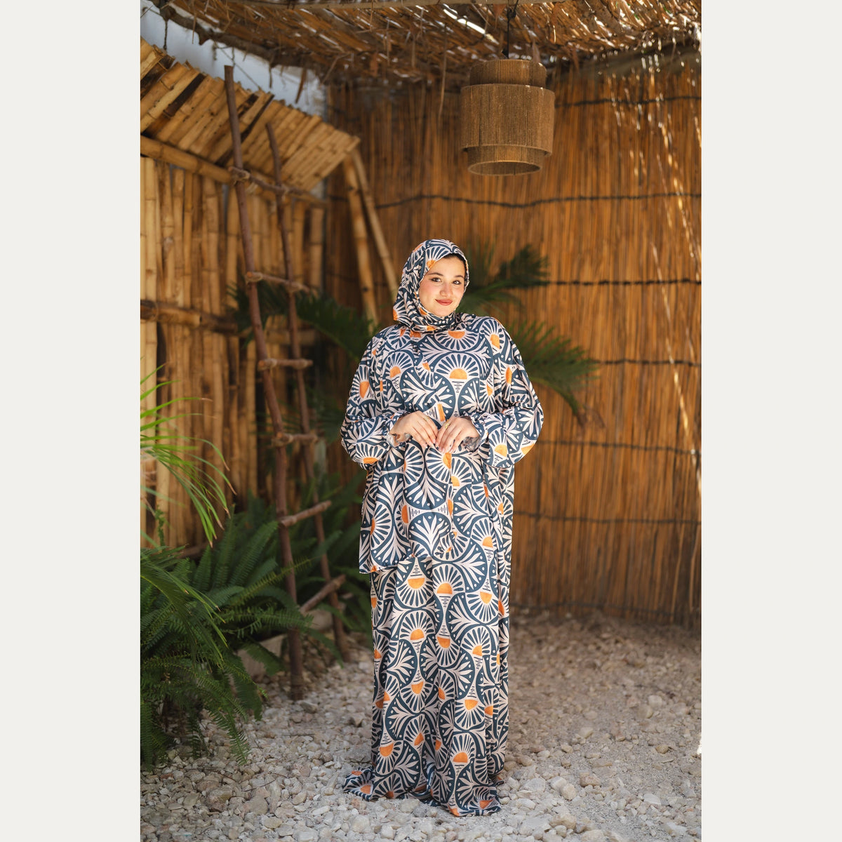 Tallah satin Isdal in Navy, Cream and Orange, fan pattern, full-length front view with hands at waist.