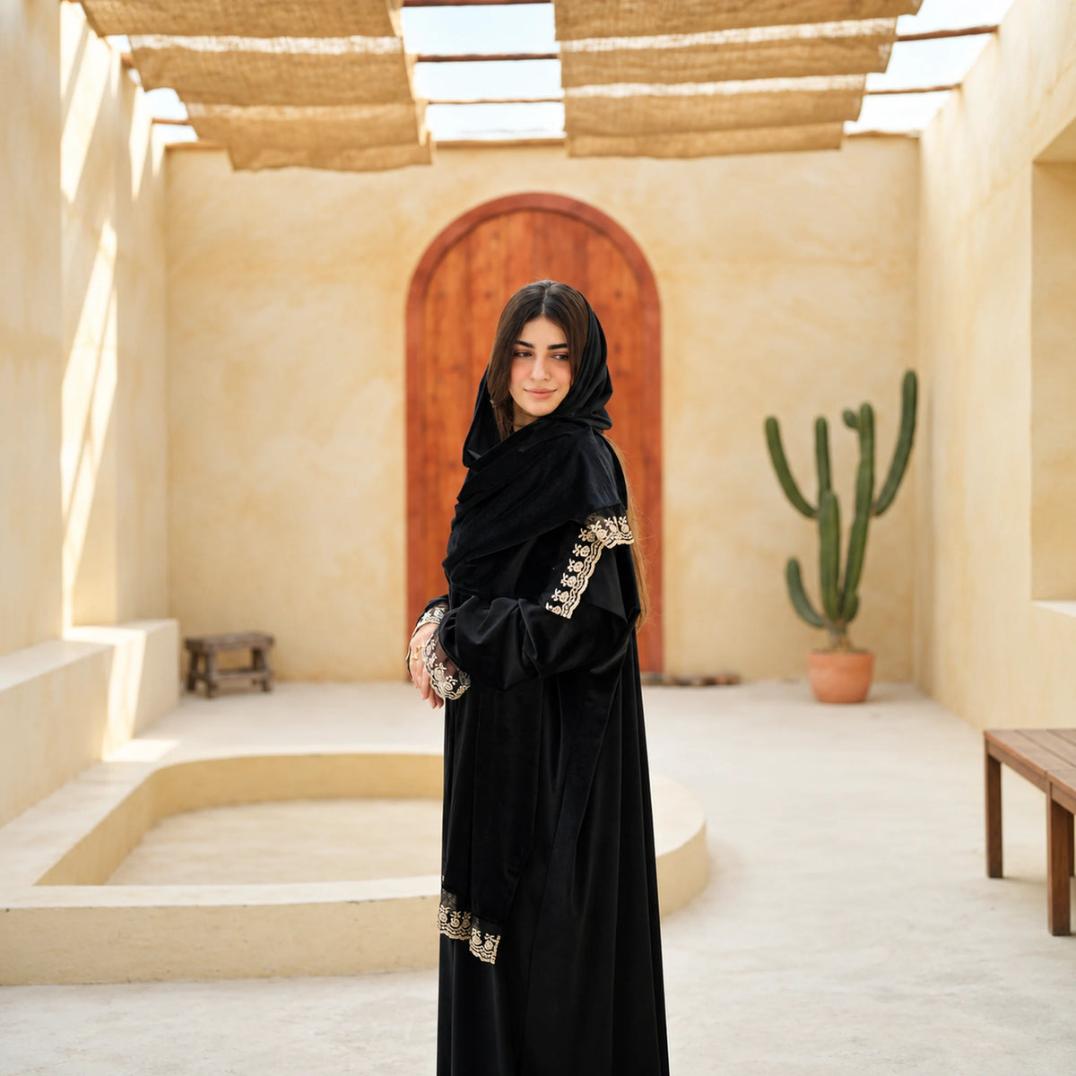 Model wearing Tallah's black Velvet Isdal with embroidered cuffs and veil trim, gallery view 1.