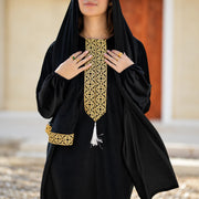 Close-up of Tallah black velvet Isdal with gold embroidered placket and cuffs