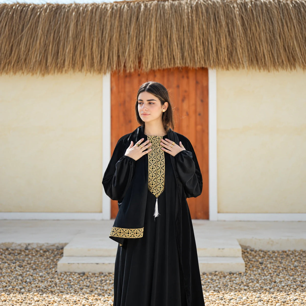Mid-length view of Tallah black velvet Isdal with gold embroidery