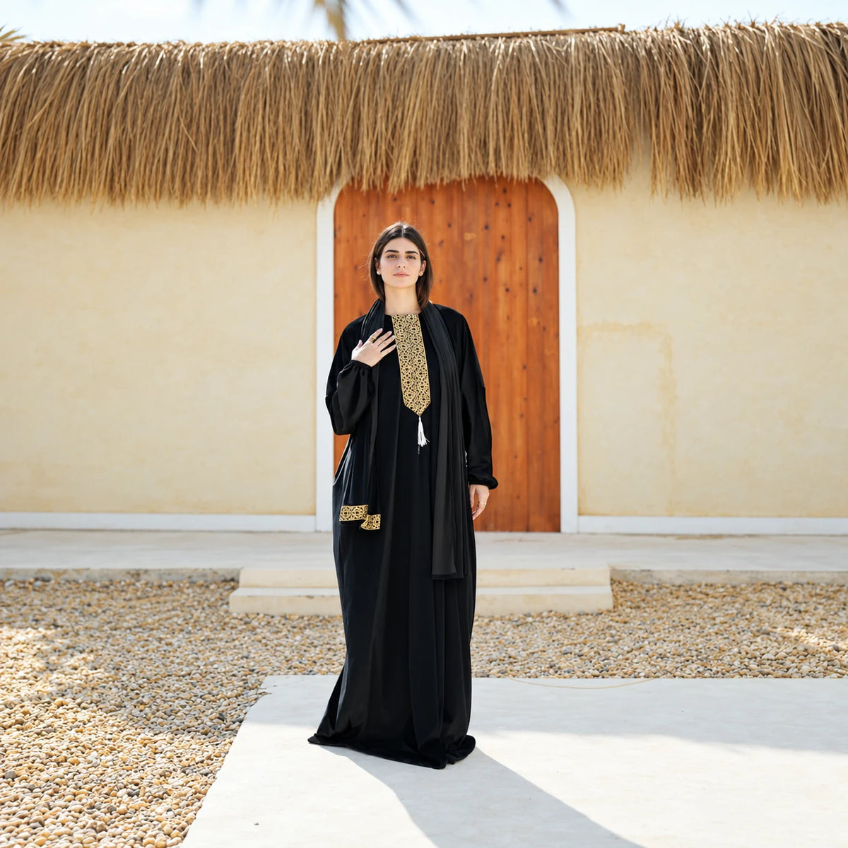 Full-length view of Tallah black velvet Isdal with gold embroidery