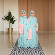 Two children wearing mint green and pink colour-block viscose Kids Isdals, full-length front view.