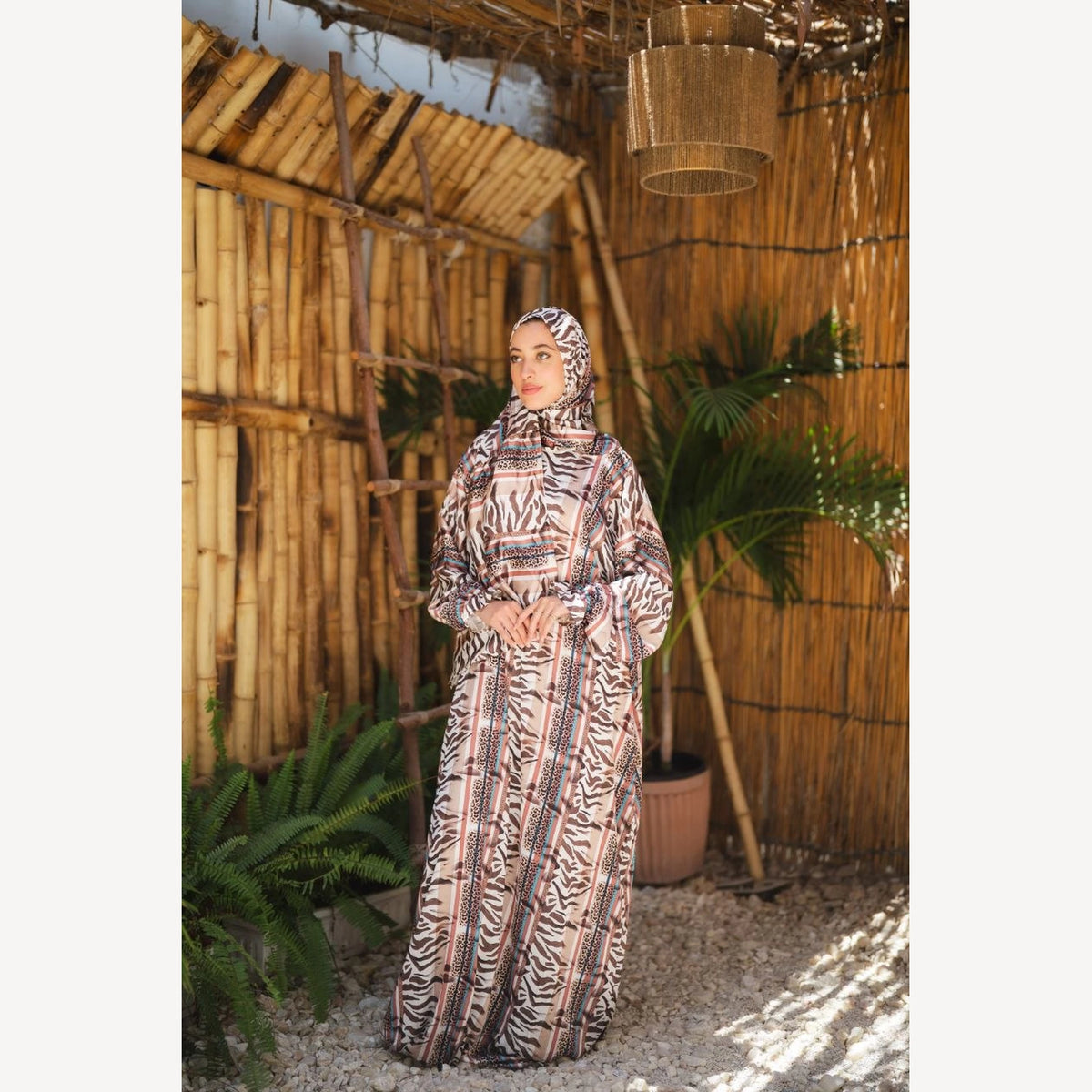 Tallah satin Isdal in beige brown animal print, full-length three-quarter view with hands together.
