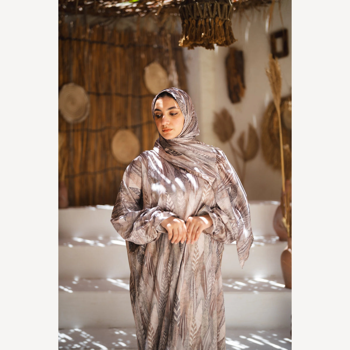 Tallah satin Isdal in beige taupe feather, closer front view with hands together.