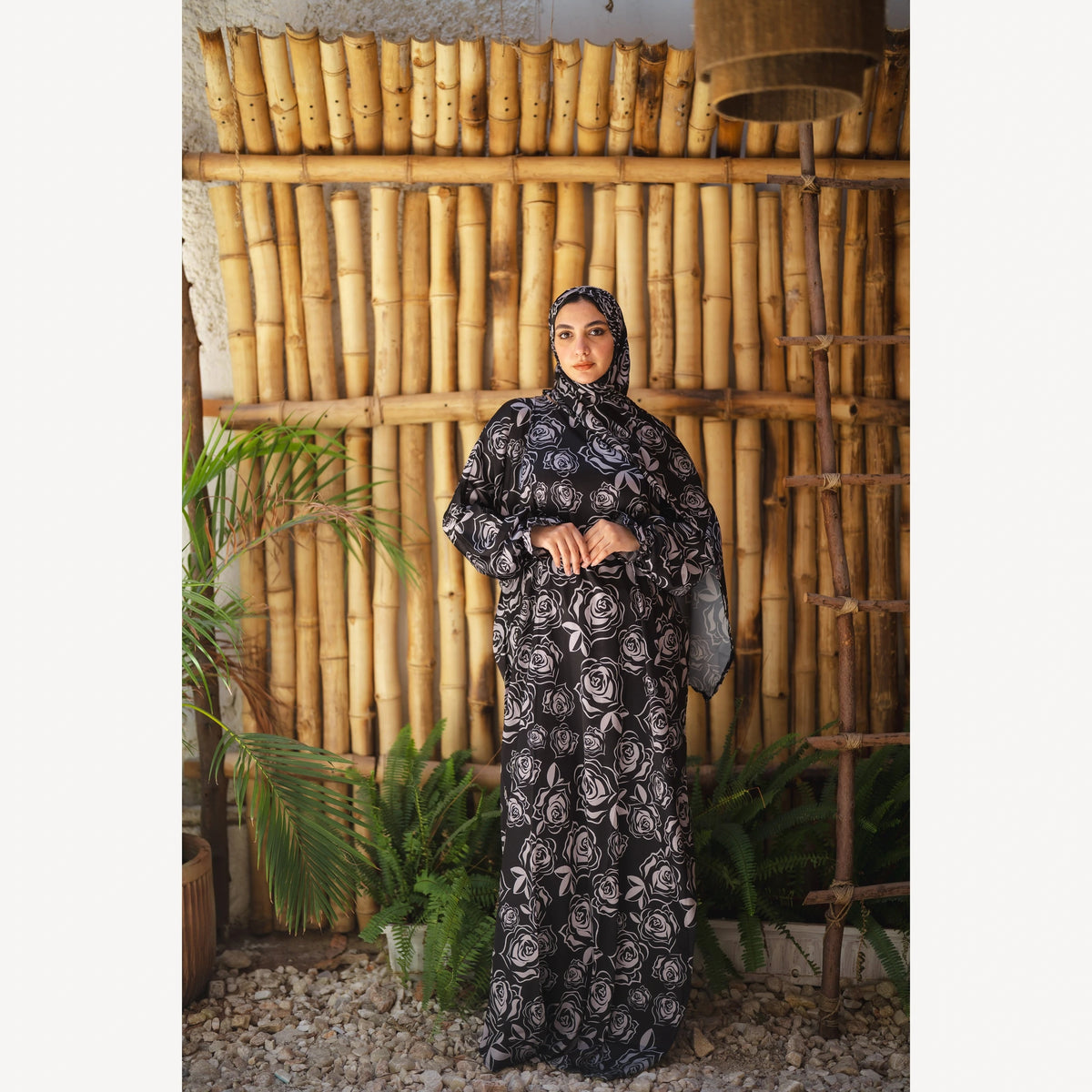 Tallah satin Isdal in black grey rose, full-length front view with hands together.
