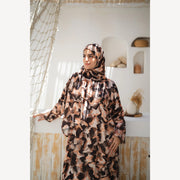 Tallah satin Isdal in brown black cream abstract, front three-quarter view with one sleeve extended.