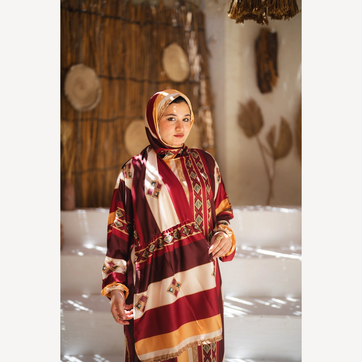Tallah satin Isdal in burgundy mustard cream striped, closer front view showing head covering and bodice.