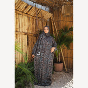Tallah satin Isdal in charcoal cream small print, full-length front view with one hand at waist.