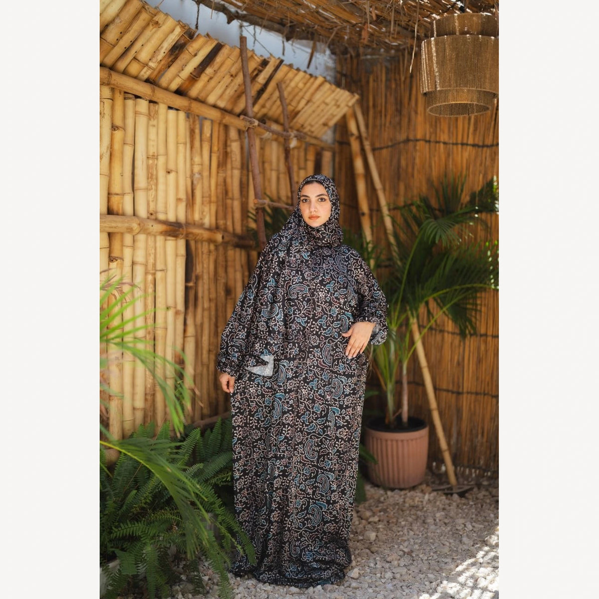 Tallah satin Isdal in charcoal cream small print, full-length front view with one hand at waist.