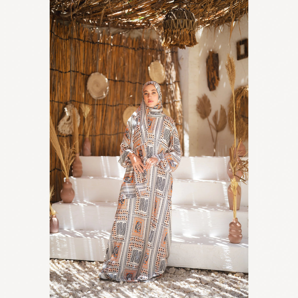 Tallah satin Isdal in cream black orange geometric, full-length front view with hands together.