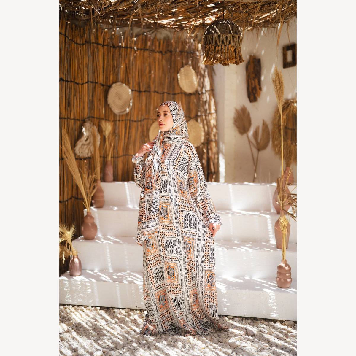 Tallah satin Isdal in cream black orange geometric, full-length three-quarter view with one arm extended.