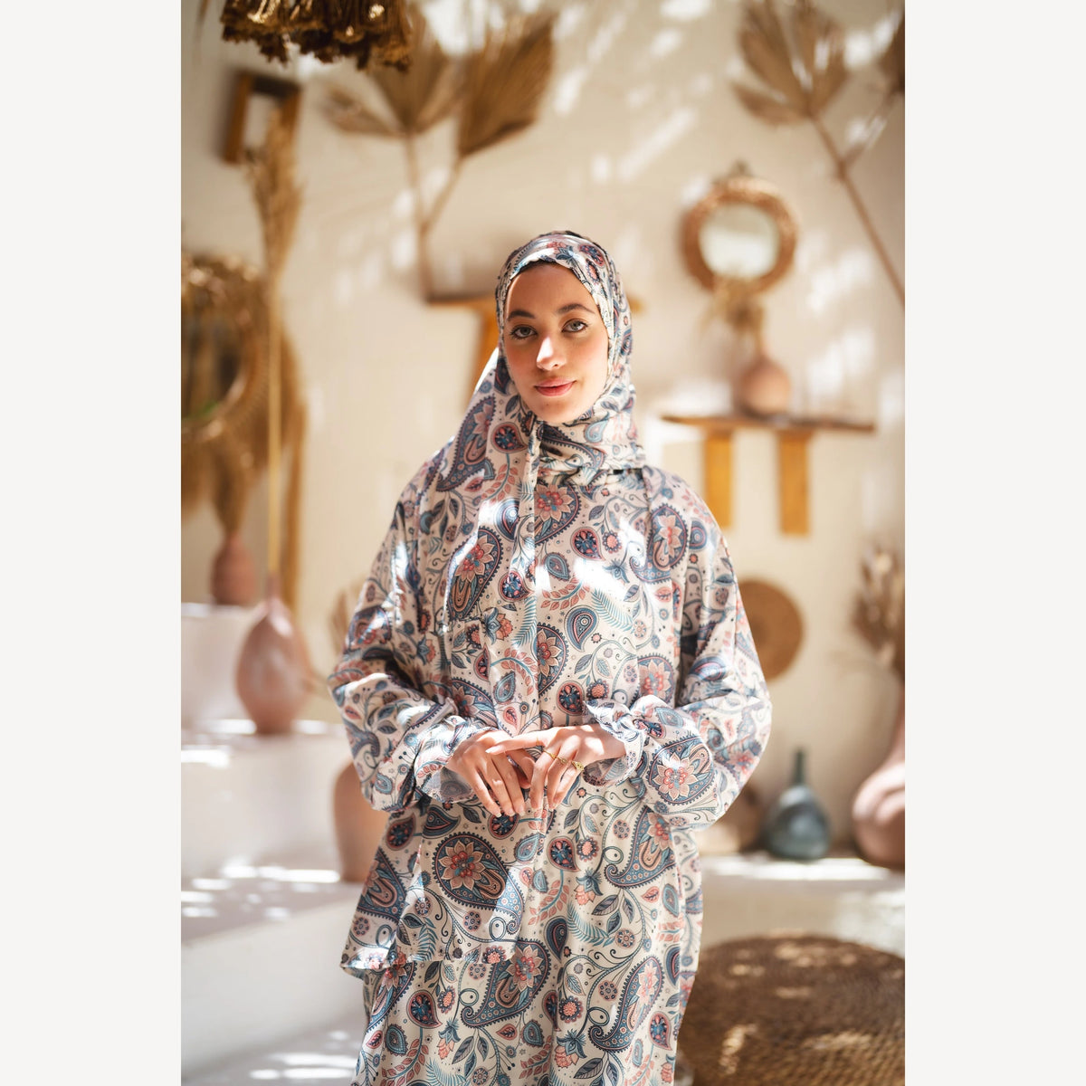 Tallah satin Isdal in cream navy rust paisley, closer front view with hands together.